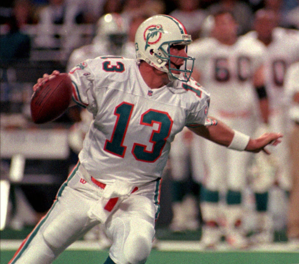 File-This Dec. 24, 1995, file photo shows Miami Dolphins quarterback Dan Marino looking for the downfield receiver against the St. Louis Rams, in St. Louis. Members of a special panel of 26 selected all of them for the position as part of the NFL's celebration of its 100th season. All won league titles except Marino. All are in the Hall of Fame except Brady and Manning, who are not yet eligible. On Friday, Dec. 27, 2019, quarterback was the final position revealed for the All-Time Team. (AP Photo/Jane Rudolph, File)