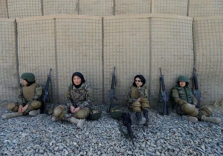 Female Afghan soldiers Shreen Yawari, 24 (L), Zarmina Ahmadi, 22 (2nd L), Fatima Alimi, 21 (3nd L), and Zahra Sultani, 20 (R), rest after shooting exercises at the Kabul Military Training Centre (KMTC) in Kabul, Afghanistan, October 26, 2016. REUTERS/Mohammad Ismail