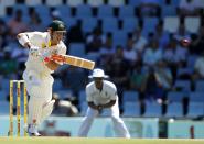 Australia's David Warner plays a shot during the first day of their cricket test match against South Africa in Centurion February 12, 2014.