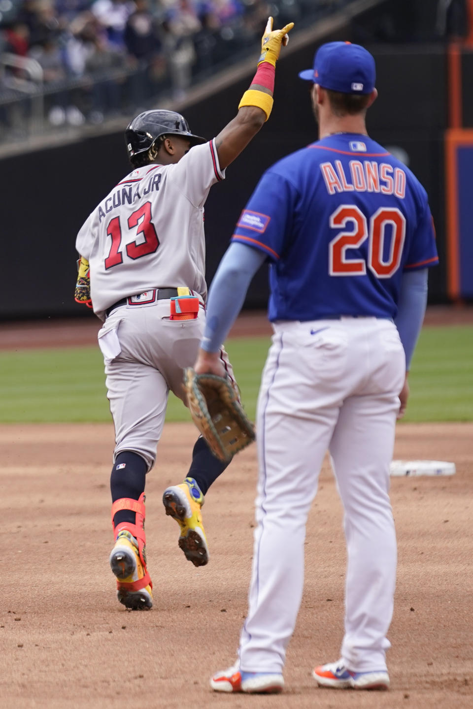 Atlanta Braves' Ronald Acuna Jr. (13) rounds the bases after hitting a home run as New York Mets' first baseman Pete Alonso, right, looks on during the second inning of the first baseball game of a doubleheader at Citi Field, Monday, May 1, 2023, in New York. (AP Photo/Seth Wenig)