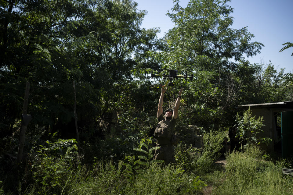 A Ukrainian solider grabs an intelligence drone during landing in the Luhansk region, Ukraine, Saturday, Aug. 19, 2023. Moscow’s army is staging a ferocious push in northeast Ukraine designed to distract Ukrainian forces from their counteroffensive and minimize the number of troops Kyiv is able to send to more important battles in the south. (AP Photo/Bram Janssen)