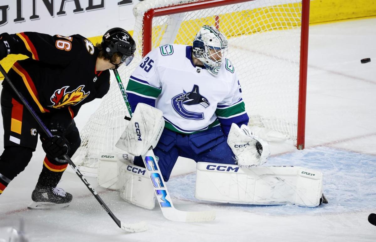 Nail-Biting Match: Canucks Hold On to Beat Flames 4-3