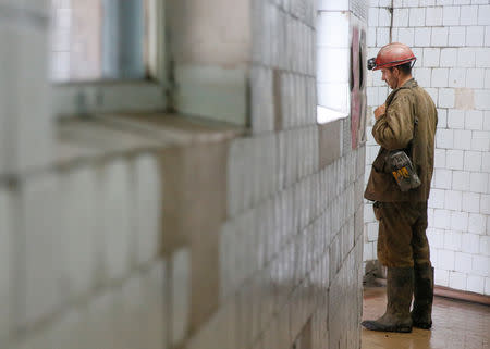 A miner stands in a corridor after the end of his shift at the Novovolynska-9 coal mine in Novovolynsk, Ukraine August 2, 2018. Picture taken August 2, 2018. REUTERS/Valentyn Ogirenko