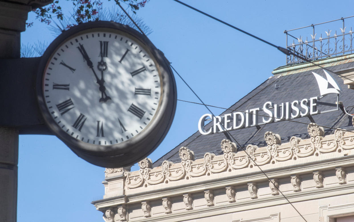 A clock is seen near the logo of Swiss bank Credit Suisse at the Paradeplatz square in Zurich, Switzerland October 5, 2022. REUTERS/Arnd Wiegmann