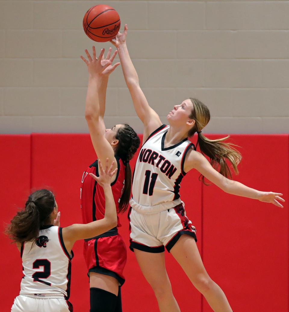 Norton guard Bailey Acord, right, jumps for a rebound against an opponent from Field during a regular-season game in 2023.