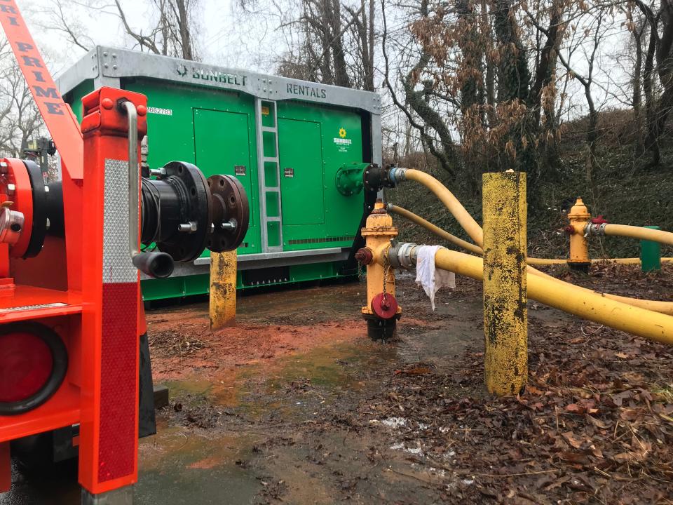 City of Asheville water resources crews hook up a pump to hydrants in Roger Farmer Memorial Park at 71 Deaverview Road on Dec. 30, 2022.