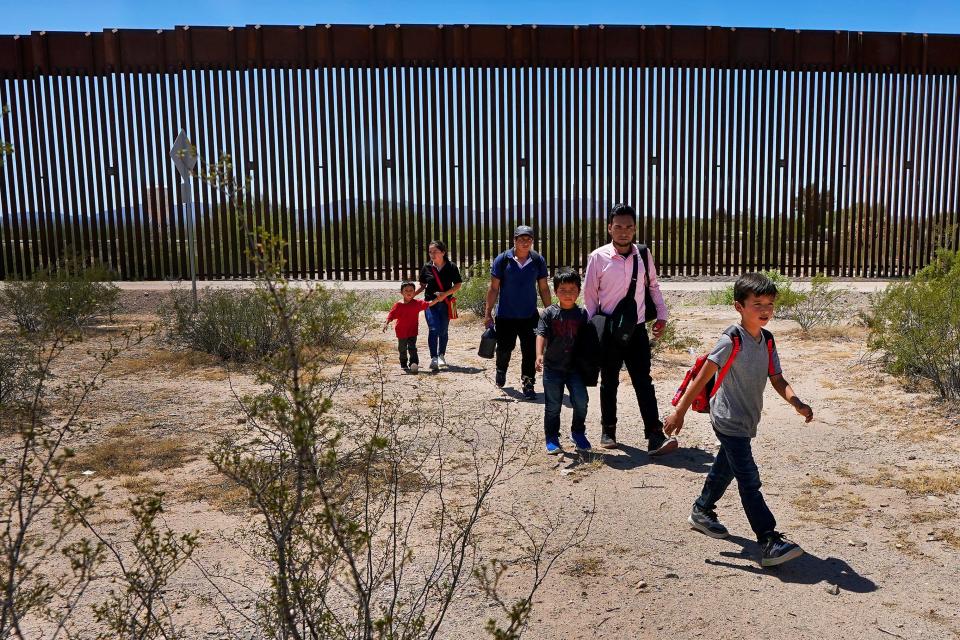 A family of five claiming to be from Guatemala and a man stating he was from Peru, in pink shirt, walk through the desert after crossing the border wall in the Tucson Sector of the U.S.-Mexico border, Tuesday, Aug. 29, 2023, in Organ Pipe Cactus National Monument near Lukeville, Ariz. U.S. Customs and Border Protection reports that the Tucson Sector is the busiest area of the border since 2008 due to smugglers abruptly steering migrants from Africa, Asia and other places through some of the Arizona borderlands' most desolate and dangerous areas. (AP Photo/Matt York) ORG XMIT: AZMY101