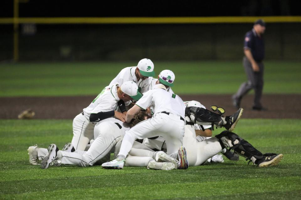 New Castle baseball celebrates after winning its regional championship against Fort Wayne Bishop Dwenger at Oak Hill High School on Saturday, June 4, 2022.