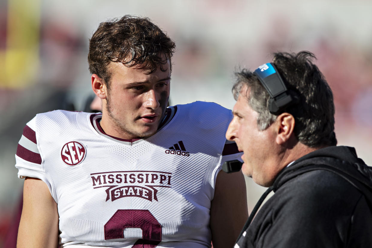 FAYETTEVILLE, ARKANSAS - NOVEMBER 6:  Will Rogers #2 talks with Head Coach Mike Leach of the Mississippi State Bulldogs on the sidelines during a game against the Arkansas Razorbacks at Donald W. Reynolds Stadium on November 6, 2021 in Fayetteville, Arkansas.  The Razorbacks defeated the Bulldogs 31-28.  (Photo by Wesley Hitt/Getty Images)