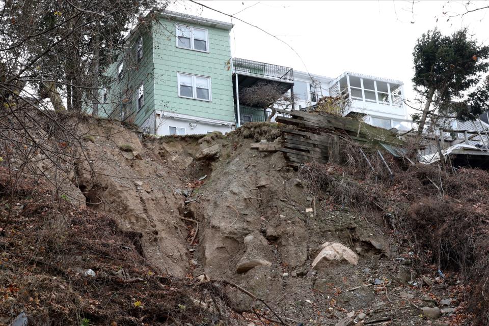 A view of the erosion below 763 Warburton Avenue in Yonkers pictured Dec. 9, 2021.  Giant stones have been placed to help stop erosion on the slope, where the rear yards of homes washed down the embankment and onto the train tracks during Hurricane Ida. 