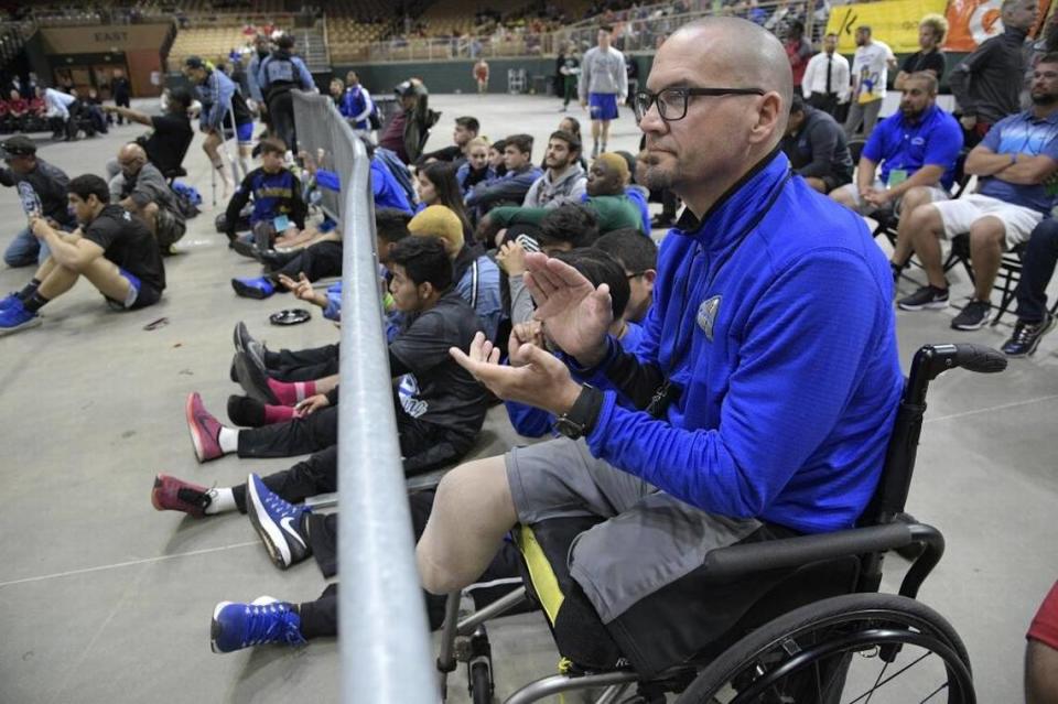 South Dade principal Javier Perez watches one of the school’s championship matches during the FHSAA State Wrestling Finals, March 4, 2017, in Kissimmee, Fla.