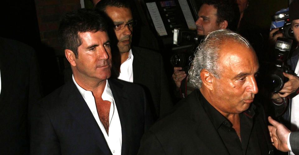 Cowell with Philip Green in 2009. (PA Images)