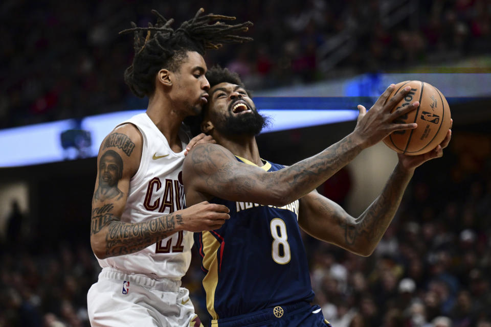 New Orleans Pelicans forward Naji Marshall drives on Cleveland Cavaliers forward Emoni Bates during the second half of an NBA basketball game Thursday, Dec. 21, 2023, in Cleveland. The Pelicans won 123-104. (AP Photo/David Dermer)