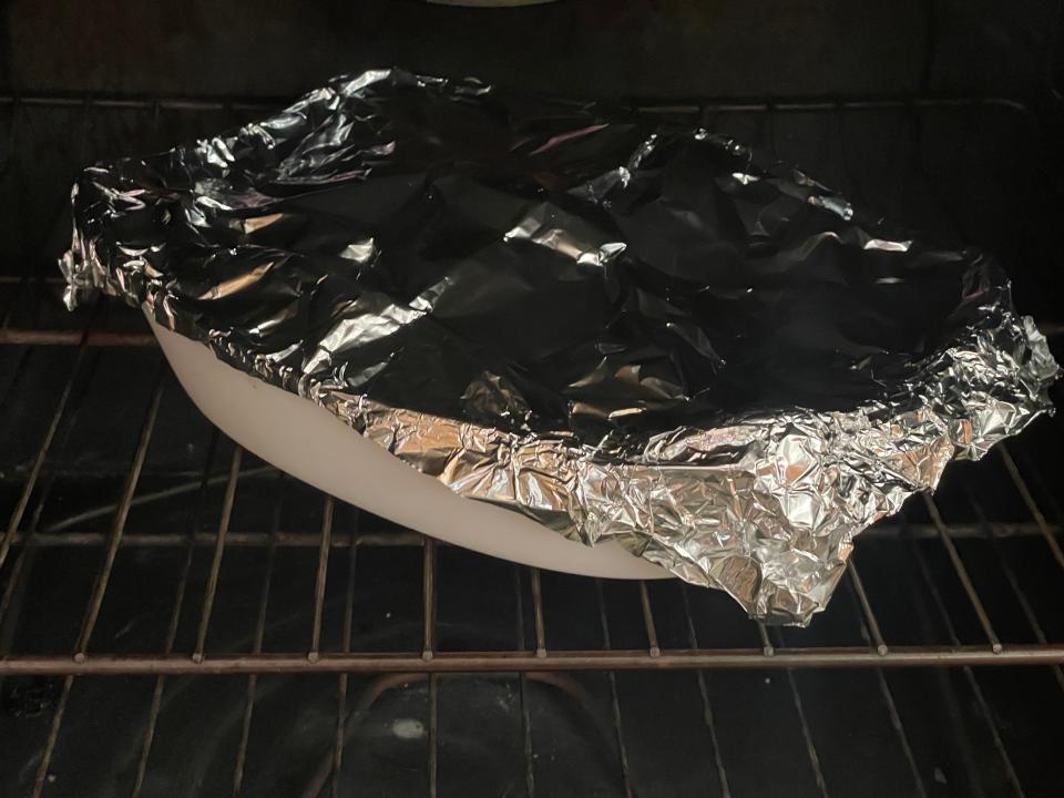 baking dish covered in aluminum foil in an oven