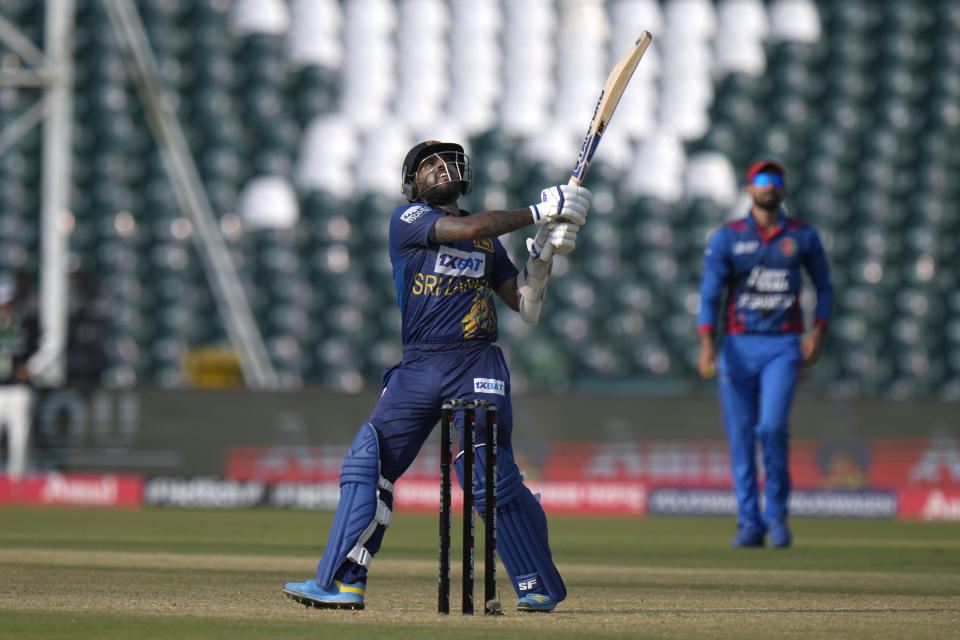 Sri Lanka's Kusal Mendis, center, follows the ball after playing a shot for six during the Asia Cup cricket match between Afghanistan and Sri Lanka in Lahore, Pakistan, Tuesday, Sept. 5, 2023. (AP Photo/K.M. Chaudary)