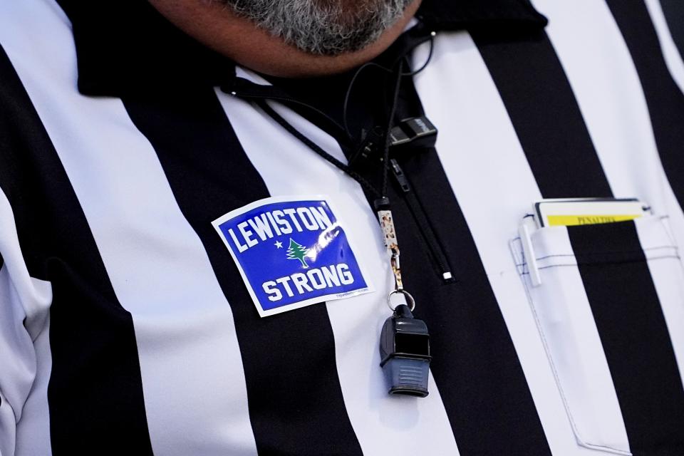 A referee wears a Lewiston Strong sticker on his jersey prior to a Lewiston High School and Edward Little High School football game, Wednesday, Nov. 1, 2023, in Lewiston, Maine. Locals seek a return to normalcy after a mass shooting on Oct. 25. (AP Photo/Matt York)