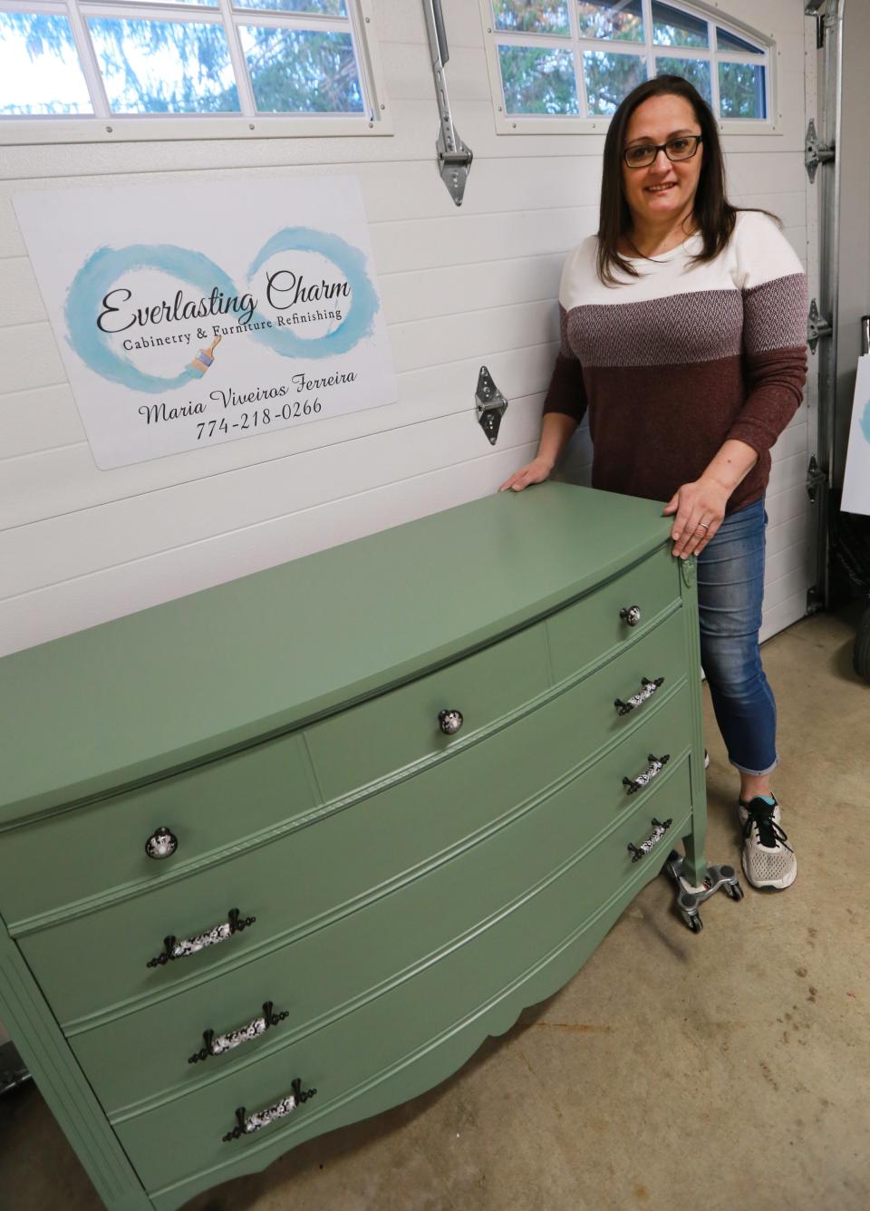 Maria Viveiros Ferreira, owner of Everlasting Charm Cabinetry & Furniture Refinishing, shows a recently completed furniture piece  in her shop on Thursday, April 28, 2022.