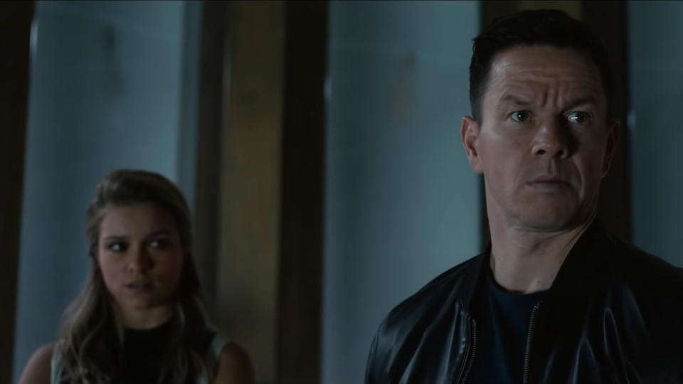 Sophie Cookson and Mark Wahlberg in a dim room in Infinite.