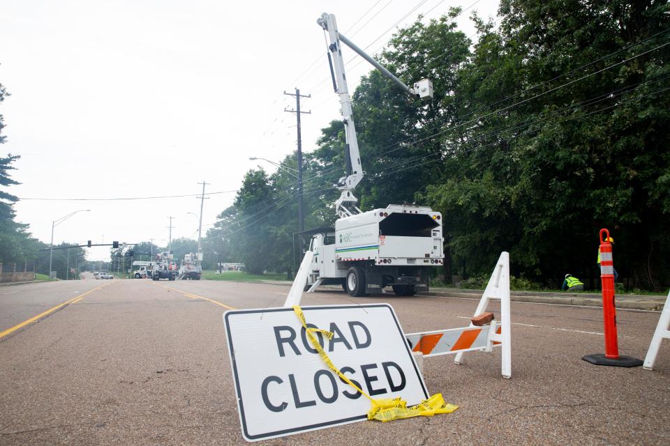 South Germantown Road is closed ahead of the intersection with Stout Road as crews work to repair power lines that fell onto the road after a storm passed through the area the previous night leaving trees and power lines down and many residents without power in Germantown, Tenn., on Wednesday, July 19, 2023.
