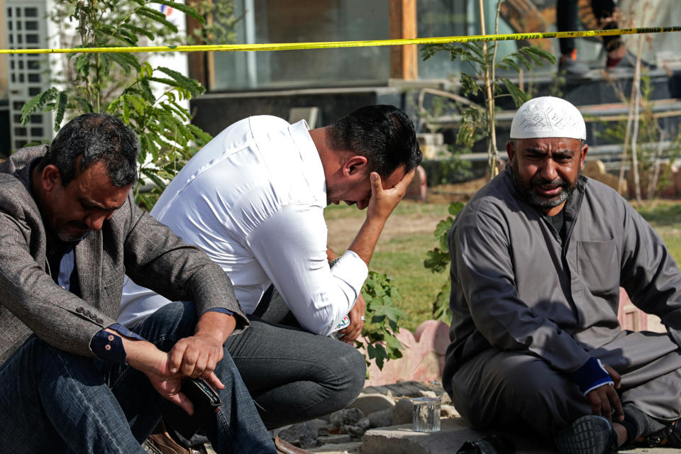 People react at the site of an explosion in Basra, Iraq, Tuesday, Dec. 7, 2021. The explosion rocked the center of Iraq’s southern city of Basra, killing at least four people and wounding several others. Local news reports initially reported a car bomb, but the governor of Basra told reporters on the scene that a motorcycle had exploded. (AP Photo/Nabil al-Jurani)