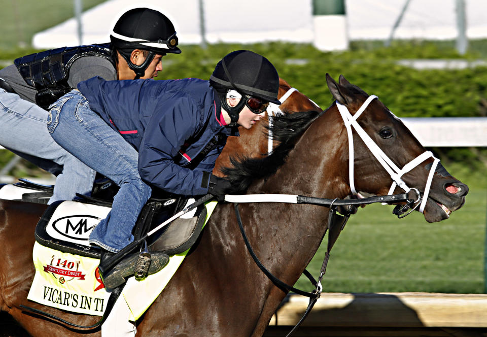 Jockey Rosie Napravnik, right, works Kentucky Derby hopeful Vicar's in Trouble with a stablemate at Churchill Downs in Louisville, Ky., Saturday, April 26, 2014. (AP Photo/Garry Jones)