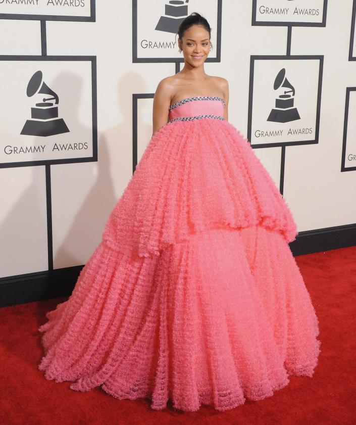 Rihanna in an oversized tulle pink ballgown with the skit starting to poof out at the top of the stomach.