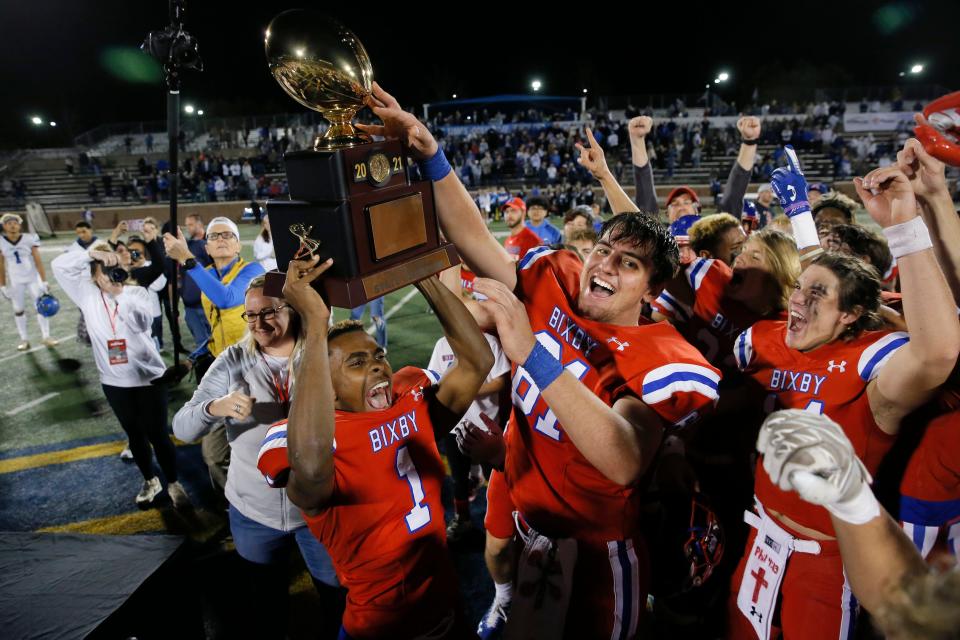 Bixby's Braylin Presley (1) and Cody Paschall (81) celebrate after beating Deer Creek for the Class 6A-II state championship Thursday night at Chad Richison Stadium in Edmond.