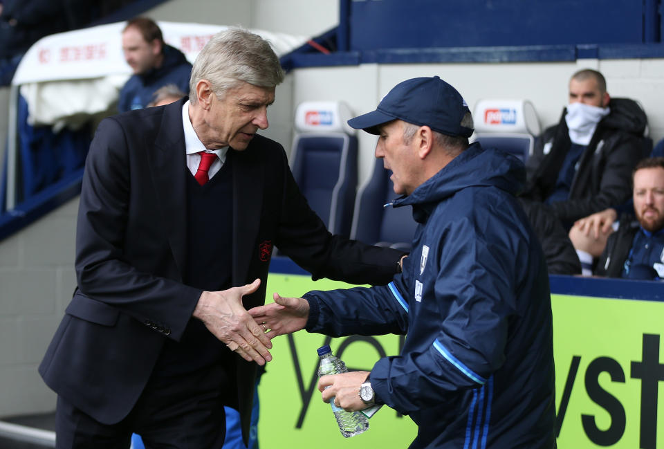 Arsene Wenger, Manager of Arsenal (L) and Tony Pulis, Manager of West Bromwich Albion (R) embrace prior to the Premier League match between West Bromwich Albion and Arsenal at The Hawthorns