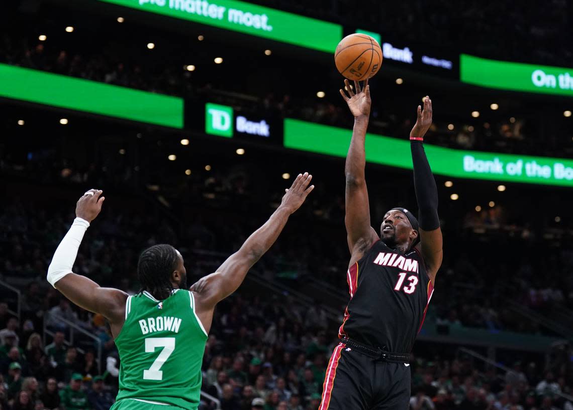 Miami Heat center Bam Adebayo shoots against Boston Celtics guard Jaylen Brown in the first quarter during Game Two of the Eastern Conference first round series on Wednesday at TD Garden in Boston. Adebayo and the Heat set a franchise record for threes made in a playoff game, shooting 23 of 43 from behind the arc in the 111-101 win.