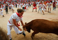 <p>A reveler tries to dodge a wild cow following the last running of the bulls at the San Fermin festival in Pamplona, northern Spain, July 14, 2017. (Photo: Susana Vera/Reuters) </p>