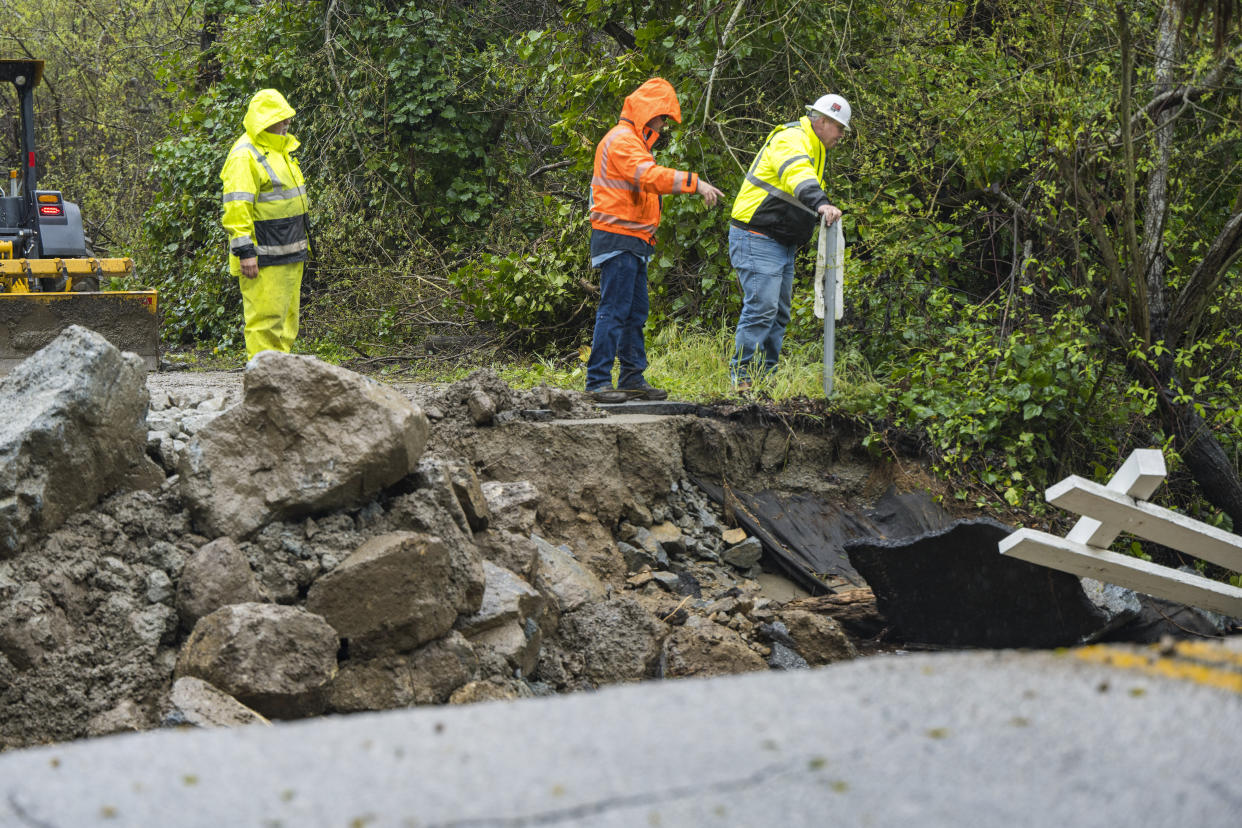 Crews assess storm damage, which washed out North Main Street in Soquel, Calif., Friday, March 10, 2023. (AP Photo/Nic Coury)