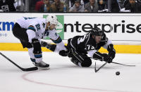 Los Angeles Kings center Tyler Toffoli, right, trips as he shoots the puck under pressure from San Jose Sharks defenseman Dan Boyle during the second period in Game 3 of an NHL hockey first-round playoff series , Tuesday, April 22, 2014, in Los Angeles. (AP Photo/Mark J. Terrill)