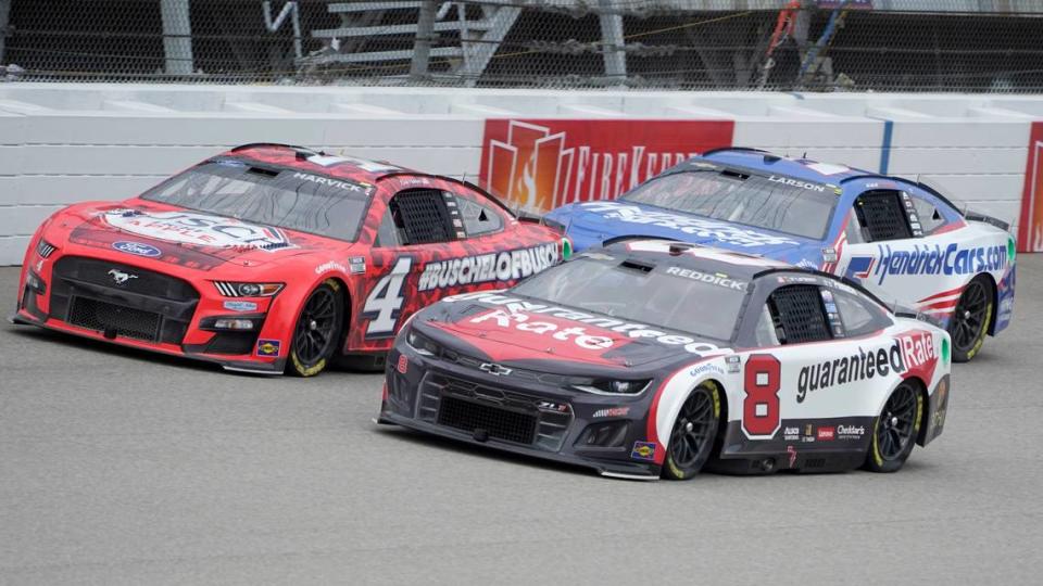 Kevin Harvick (4), Tyler Reddick (8) and Kyle Larson (5) race in the NASCAR Cup Series auto race at the Michigan International Speedway in Brooklyn, Mich., Sunday, Aug. 7, 2022. (AP Photo/Paul Sancya)