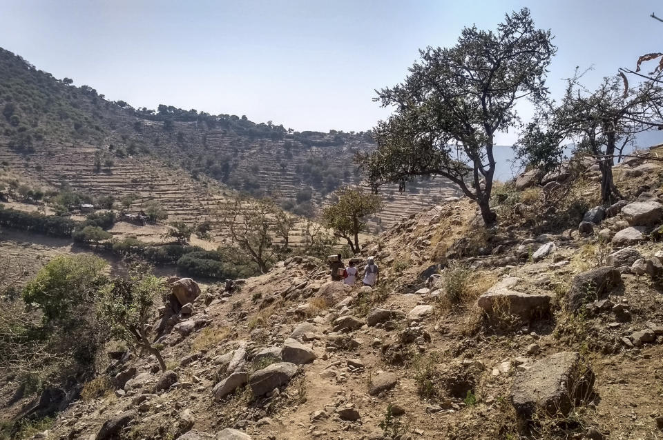 A team from Medecins Sans Frontieres carries medicines on their backs across a hillside in Tsaeda Emba, in the Tigray region of northern Ethiopia Friday, Feb. 12, 2021. The United Nations in its latest humanitarian report on the situation in Tigray says the "humanitarian situation continues to deteriorate" as fighting intensifies across the northern region. (Medecins Sans Frontieres via AP)