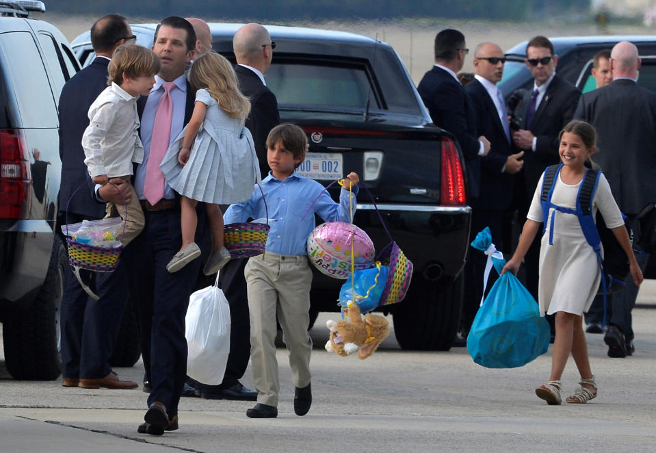 Donald Trump, Jr. carries two of his children as two others trail behind him as they disembark from Air Force One, after an Easter weekend with father President Donald Trump at the Mar-a-Lago estate in Florida, as they return to Joint Base Andrews, Maryland, in suburban Washington, U.S., April 16, 2017. REUTERS/Mike Theiler