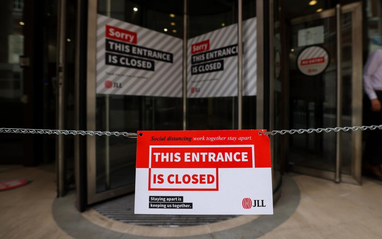 An closed sign outside the entrance to an office building in the City of London, U.K., on Monday, June 7, 2021. Three lockdowns have left the U.K.â€™s financial center transformed.  - Chris Ratcliffe/Bloomberg