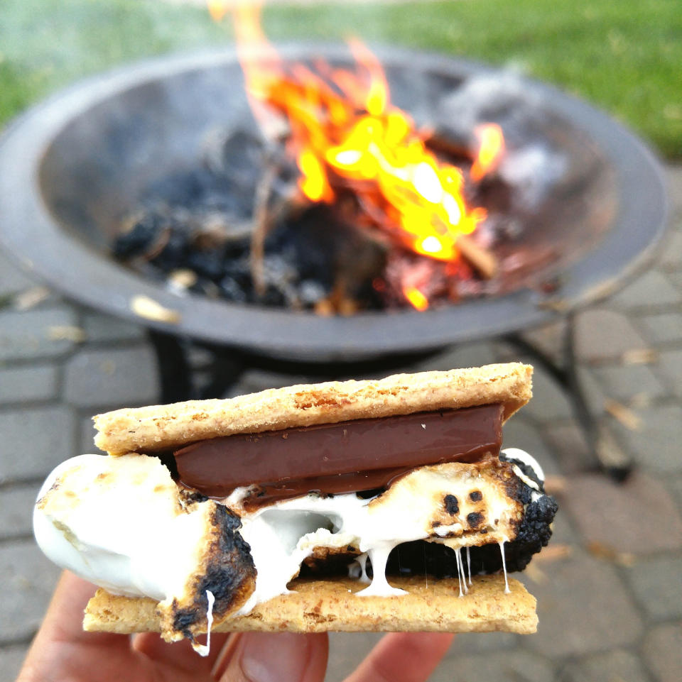 Close-up of s'more before a firepit