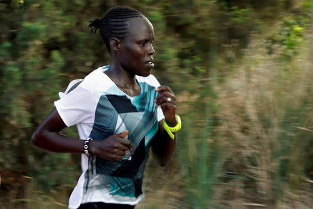 Lonah Chemtai, a Kenyan-born runner who will represent Israel in the women's marathon at the 2016 Rio Olympics, trains with her husband and coach, Israeli Dan Salpeter, near their house in Moshav Yanuv, central Israel July 14, 2016. REUTERS/Baz Ratner