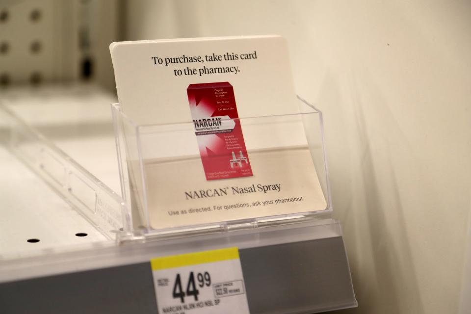 Cards on the shelf near the pharmacy that can be taken to the pharmacist to purchase Narcan, a nasal spary that can help reverse on overdose from opioid use.