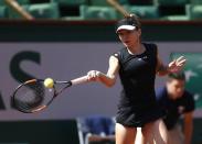 Simona Halep of Romania plays a shot to Evgeniya Rodina of Russia during their women's singles match at the French Open tennis tournament at the Roland Garros stadium in Paris, France, May 24, 2015. REUTERS/Vincent Kessler