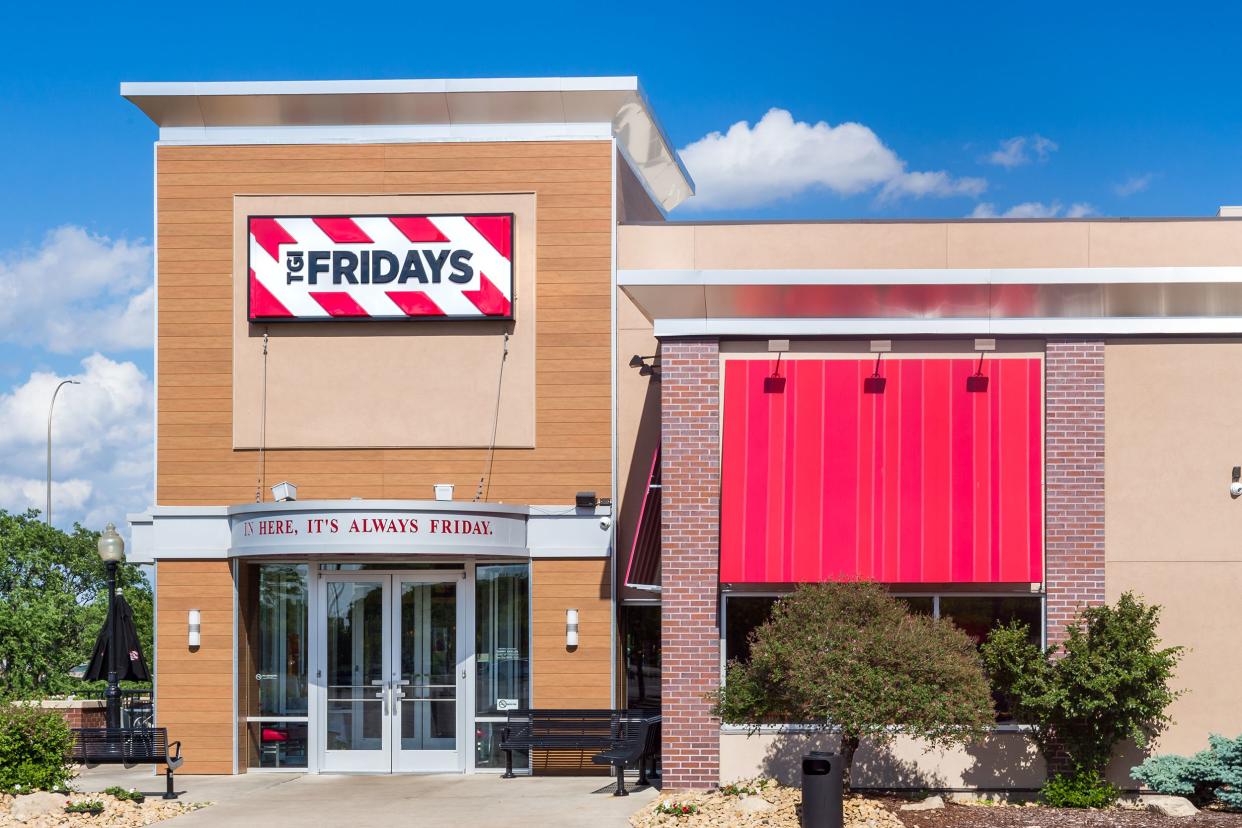 Front exterior of a TGI Friday's restaurant in Bloomington, Minnesota with garden surrounding on a bright sunny day in summer