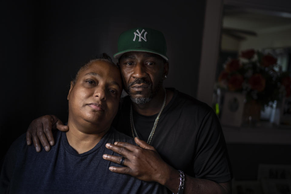 Navada Gwynn, right, and his wife Krista, stand together for a portrait in their home in Louisville, Ky., Tuesday, Aug. 29, 2023. Krista recalls that after their 19-year-old son, Christian, was killed in a drive-by shooting four blocks from home in 2019, Navada blamed himself for not doing more to protect him. Just two years later, their daughter, Victoria, then also 19, was shot and injured at a park. Now the Gwynns have pulled their youngest child, Navada, out of school, home schooling to keep her safe. (AP Photo/David Goldman)