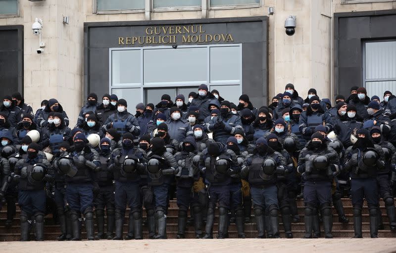 Law enforcement officers stand guard near the Government House during a rally held by supporters of Moldovan President-elect Maia Sandu in Chisinau