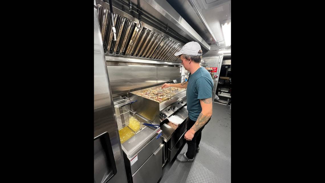 Matt King, the owner of Bellingham’s newest food truck, Doug’s Burgers cooking in his truck.