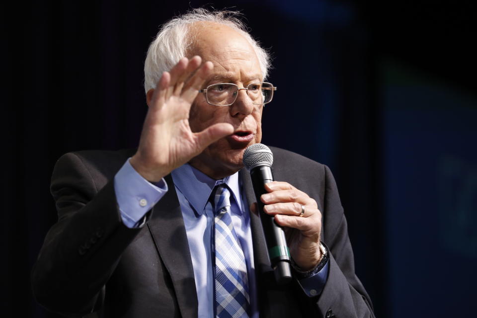 Democratic presidential candidate Sen. Bernie Sanders, I-Vt., speaks at the J Street National Conference, with the hosts of "Pod Save the World," Tommy Vietor, left, and Ben Rhodes, Monday, Oct. 28, 2019, in Washington. (AP Photo/Jacquelyn Martin)