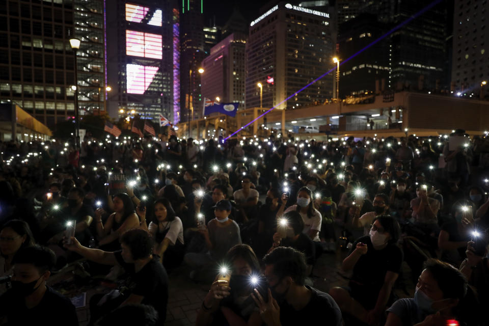 Protesters fresh their smartphone's lights to support the prayer rally at Edinburgh Place in Hong Kong, Saturday, Oct. 19, 2019. Hong Kong pro-democracy protesters are set for another weekend of civil disobedience as they prepare to hold an unauthorized protest march to press their demands. (AP Photo/Mark Schiefelbein)