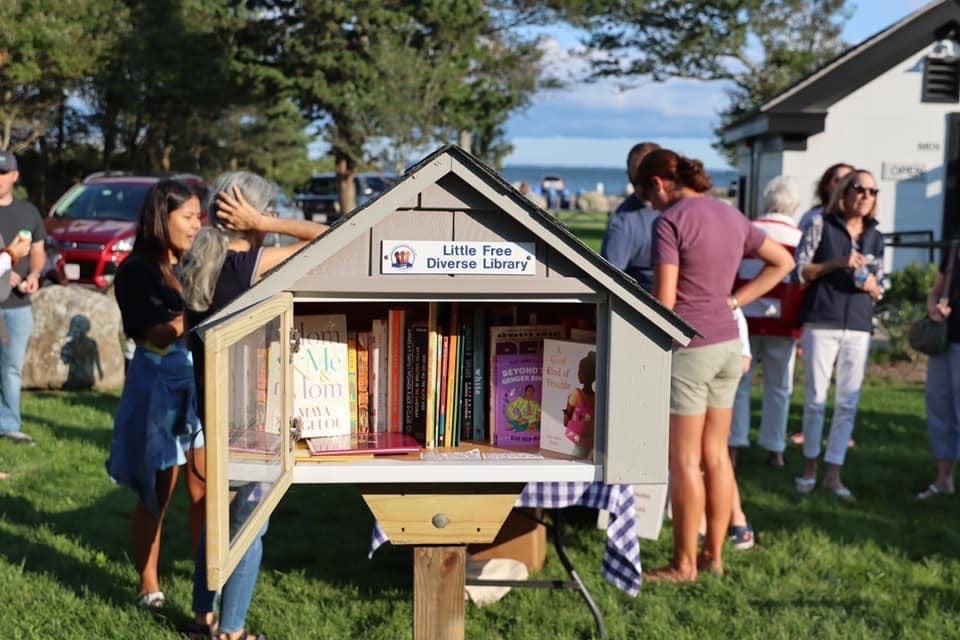 Locals are seen gathered around Tri-Town Against Racism's Little Free Diverse Library at Ned's Point in Mattapoisett. TARR members say the library boxes, containing selections of books picked out to reflect as much diversity as possible, are one way they are working to make diverse reading materials available. As of Tuesday, a discussion on the proposed ban of several books from Old Rochester High School and junior high libraries was on the agenda for TARR's Wednesday meeting, group member and Rochester resident Rhonda Baptiste said.