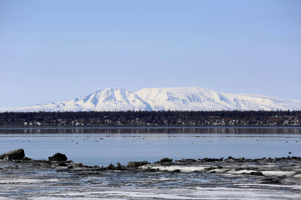 FILE - Mount Susitna, which is also known as Sleeping Lady, is shown Friday, April 16, 2021, on the other side of Cook Inlet from downtown Anchorage, Alaska. Researchers have concluded there is a "rare but real risk" that an earthquake-produced tsunami could inundate parts of coastal Anchorage under certain conditions, a newspaper reported, a shift from the prior understanding of the risk posed to Alaska's largest city. (AP Photo/Mark Thiessen,File)