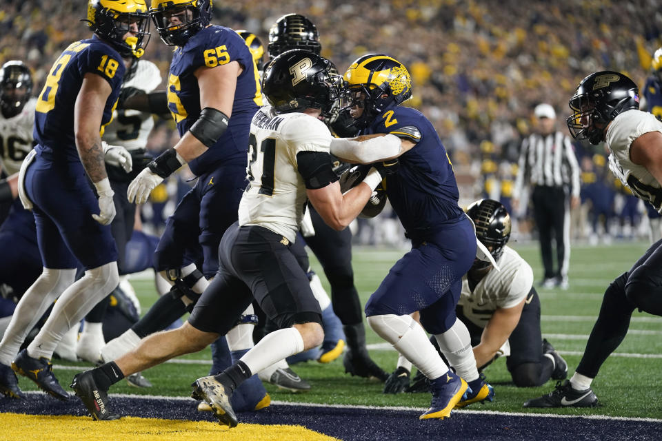 Michigan running back Blake Corum (2) rushes for a touchdown as Purdue defensive back Dillon Thieneman (31) defends in the first half of an NCAA college football game in Ann Arbor, Mich., Saturday, Nov. 4, 2023. (AP Photo/Paul Sancya)