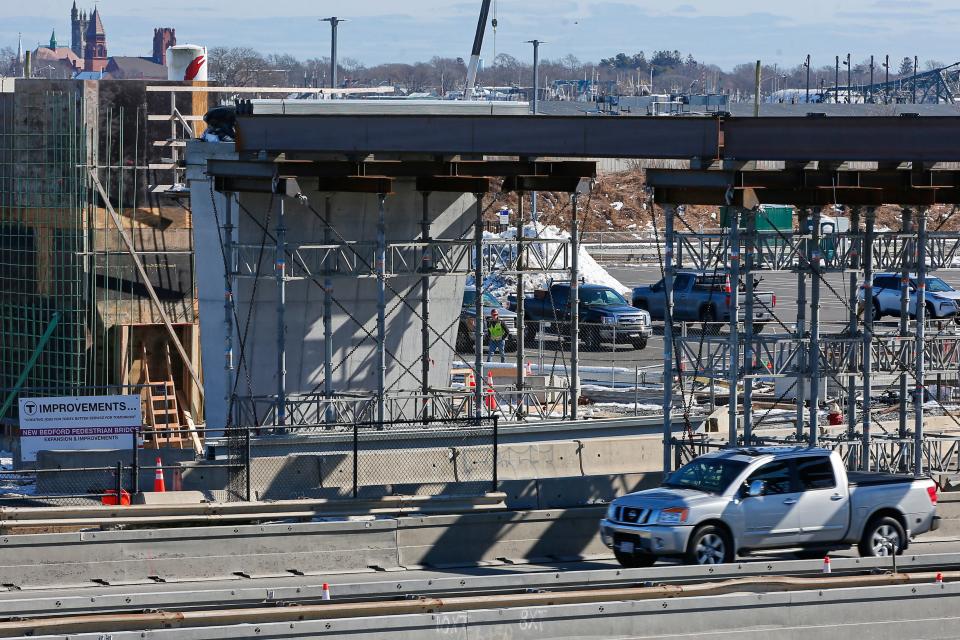 The first two beams spanning above Route 18 northbound, were laid down for the pedestrian overpass connecting Purchase Street to the Whale Tale commuter rail station in New Bedford.